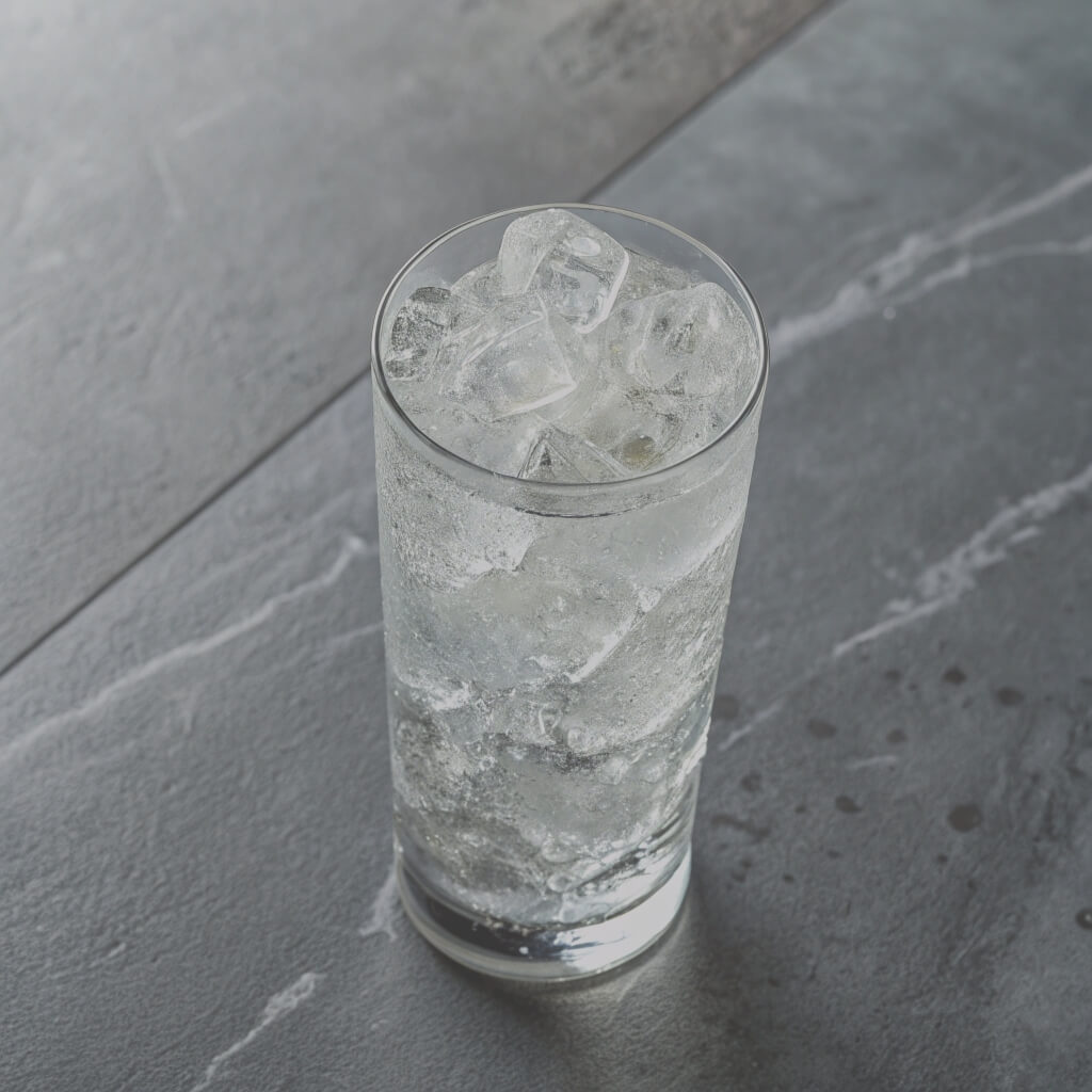A glass of ice water on a wooden table, reflecting light and surrounded by a calm, neutral setting. plus gin
