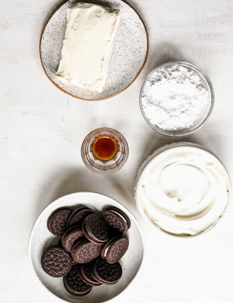 1 package (8 oz) cream cheese, softened
1 cup powdered sugar
1 container (16 oz) whipped topping, thawed
1 package (14.3 oz) Oreo cookies, crushed
1 cup milk
1 teaspoon vanilla extract
