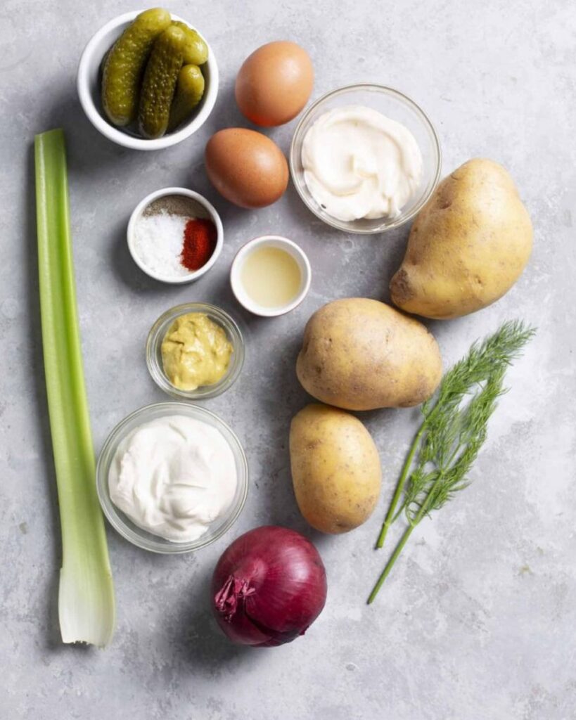 2 pounds of potatoes
1 cup mayonnaise
1 tablespoon mustard
1/2 cup diced onions
1/2 cup diced celery
1/4 cup chopped pickles
Salt and pepper to taste
Paprika for garnish