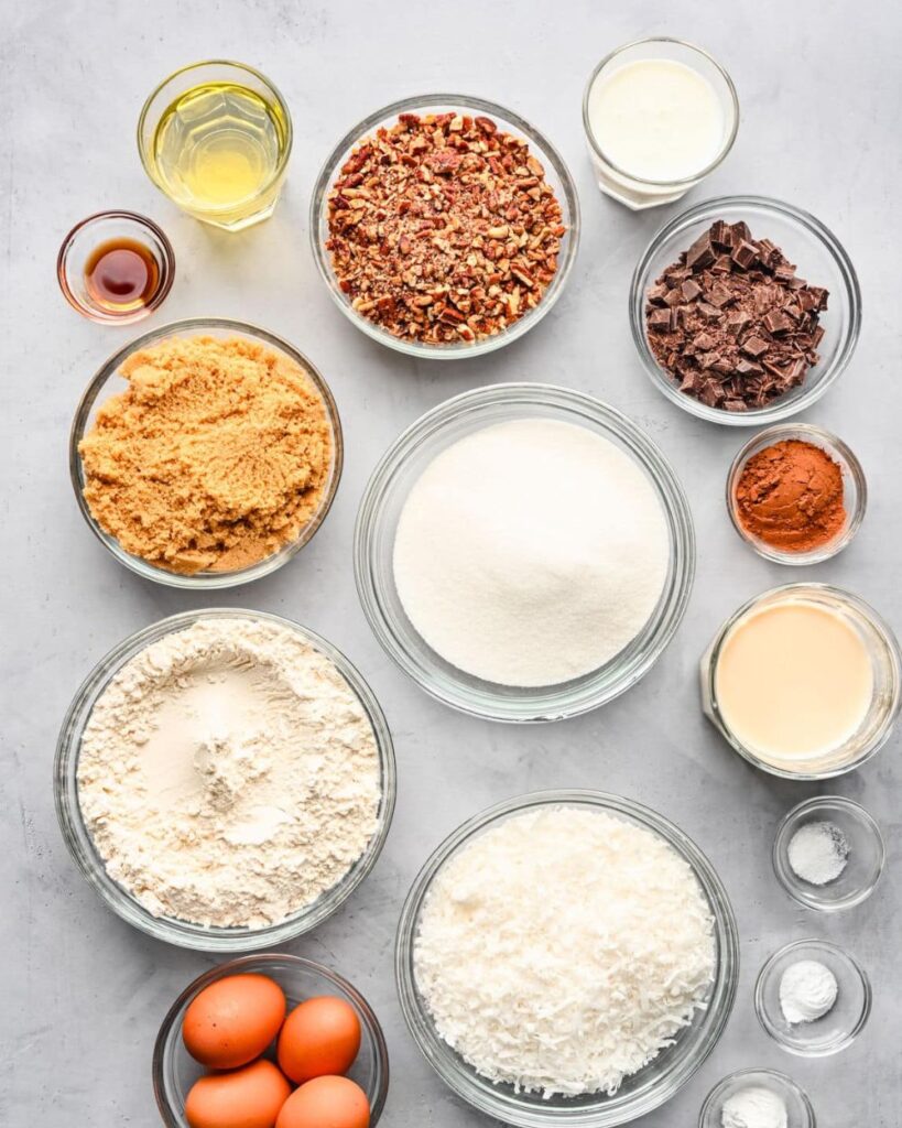 1 cup chopped pecans,
1 cup sweetened flaked coconut,
2 cups all-purpose flour,
2 cups granulated sugar,
1 cup unsweetened cocoa powder,
1 teaspoon baking soda,
1 teaspoon baking powder,
1 teaspoon salt,
1 cup unsalted butter, softened,
4 large eggs,
1 cup buttermilk,
2 teaspoons vanilla extract
