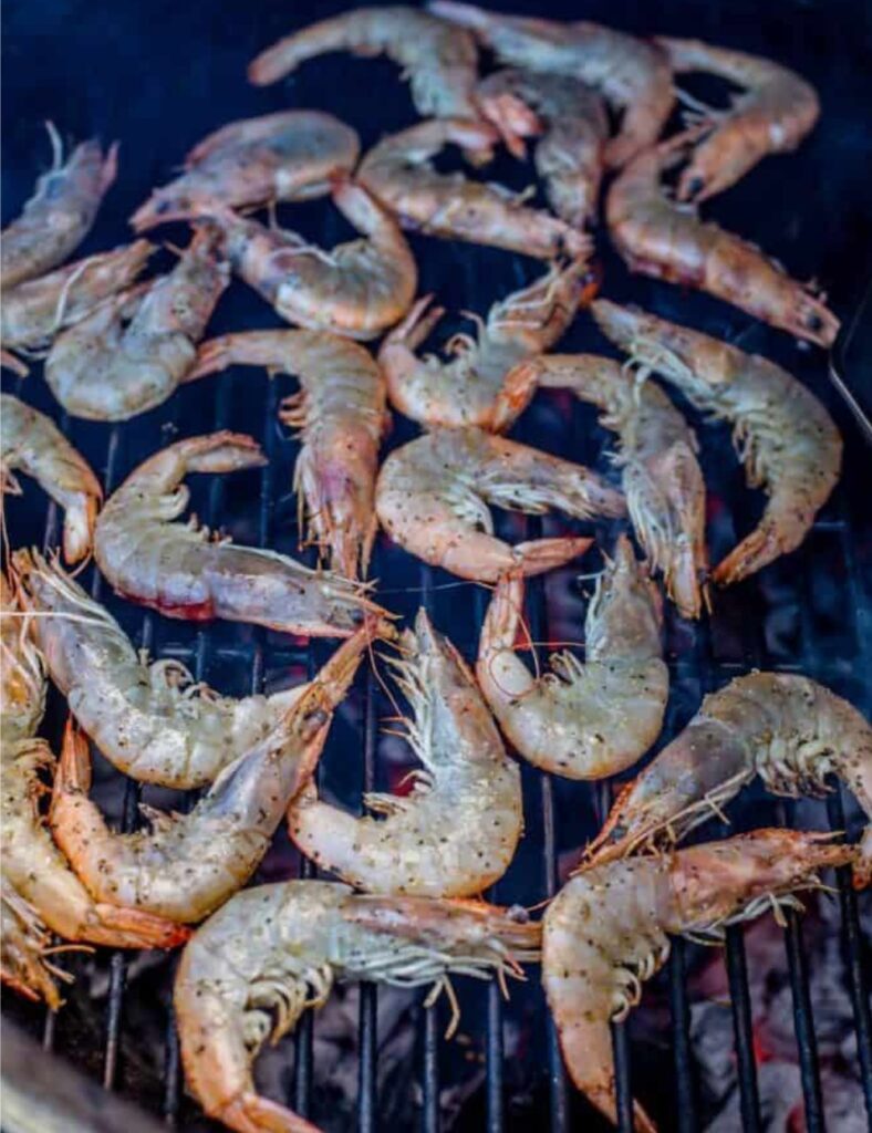 Place the skewered prawns on the grill. Grill for about 2-3 minutes on each side, or until they turn pink and are opaque in color.