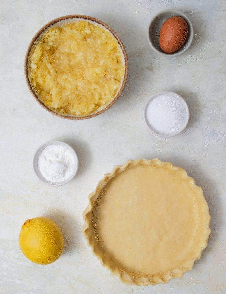 1 prepared pie crust,
2 cups fresh pineapple chunks,
1 cup sugar,
1/4 cup cornstarch,
1/4 teaspoon salt,
1/2 teaspoon vanilla extract,
1 tablespoon lemon juice,
1 tablespoon butter