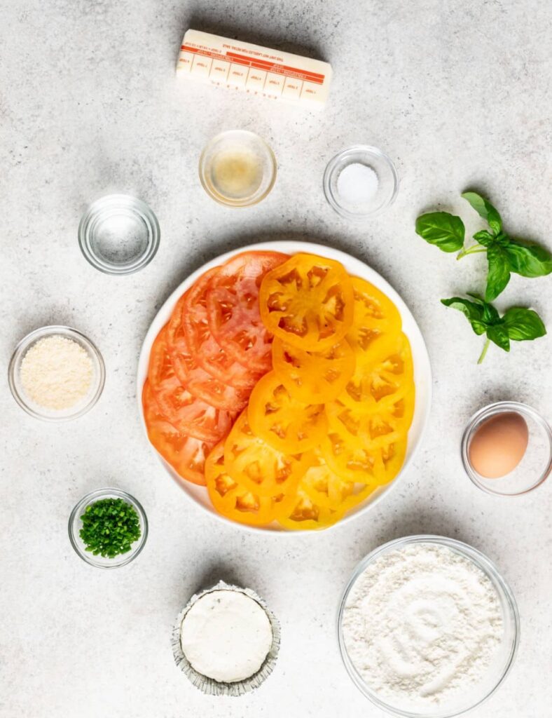 a plate of sliced tomatoes and other ingredients