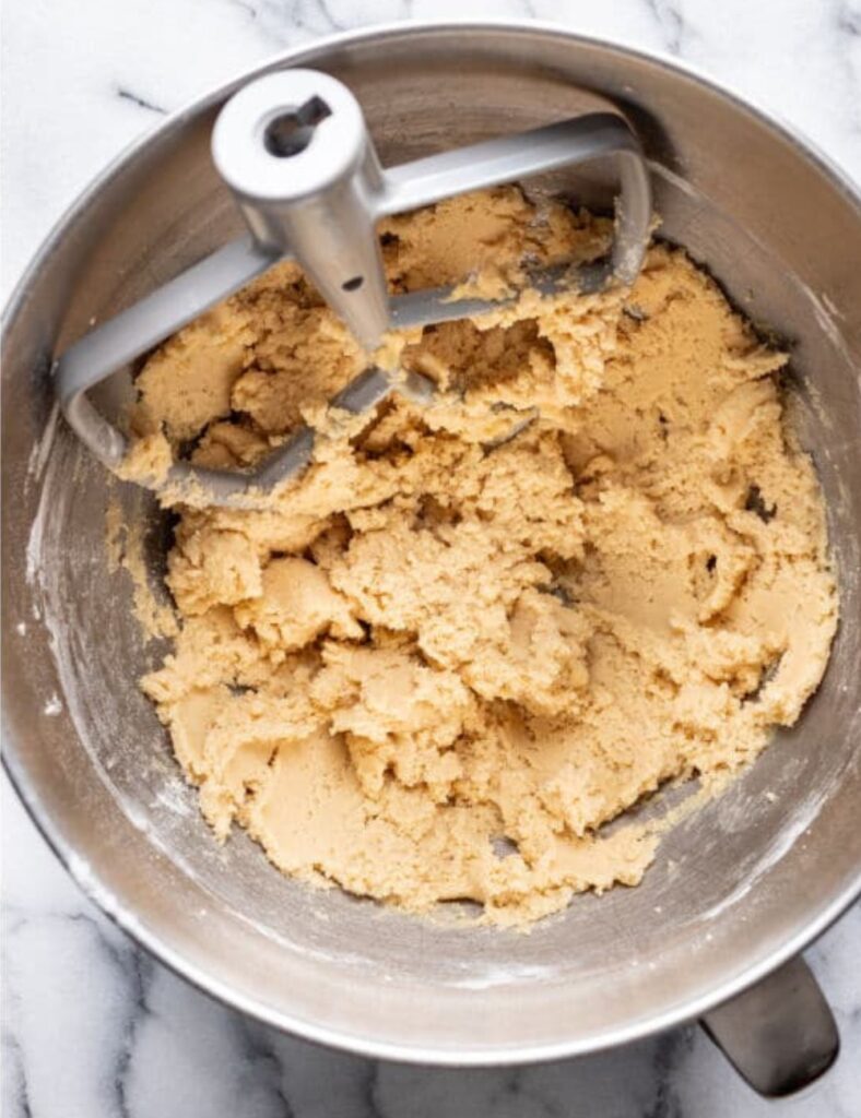 In a bowl, cream together the softened butter and sugar until light and fluffy.