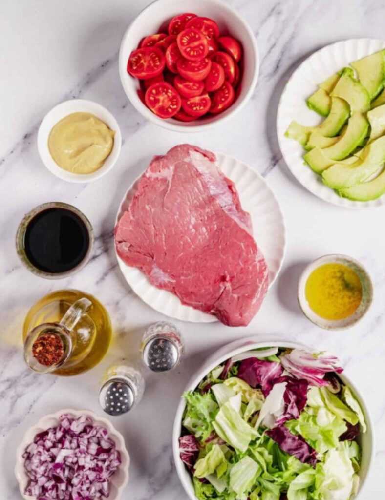 1 lb steak
4 cups mixed greens
1 cup cherry tomatoes, halved
1/2 cucumber, sliced
1/4 red onion, thinly sliced
1/4 cup blue cheese, crumbled
1/4 cup balsamic vinaigrette
Salt and pepper to taste