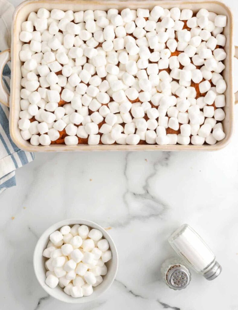 Sprinkle the mini marshmallows evenly over the top of the sweet potato mixture. If you’re adding pecans, sprinkle those on as well for some extra crunch.