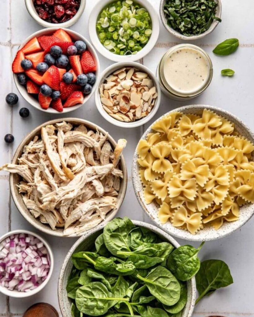 8 oz pasta (such as farfalle or penne)
1 cup cooked chicken, diced
1 cup mixed berries (strawberries, blueberries, raspberries)
1/4 cup red onion, thinly sliced
1/4 cup feta cheese, crumbled
1/4 cup basil, chopped
1/4 cup balsamic vinaigrette
Salt and pepper to taste