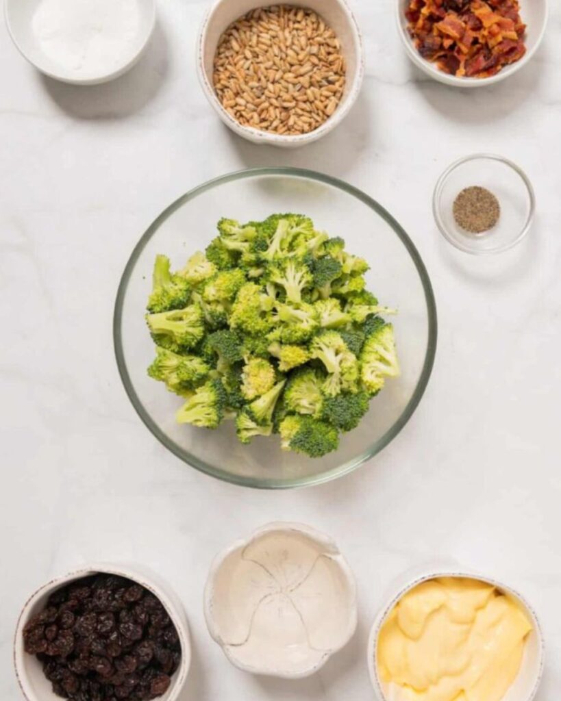 2 cups broccoli florets,
1/2 cup raisins,
1/2 cup chopped red onion,
1/2 cup sunflower seeds,
1 cup mayonnaise,
2 tablespoons apple cider vinegar,
1 tablespoon sugar,
Salt and pepper to taste