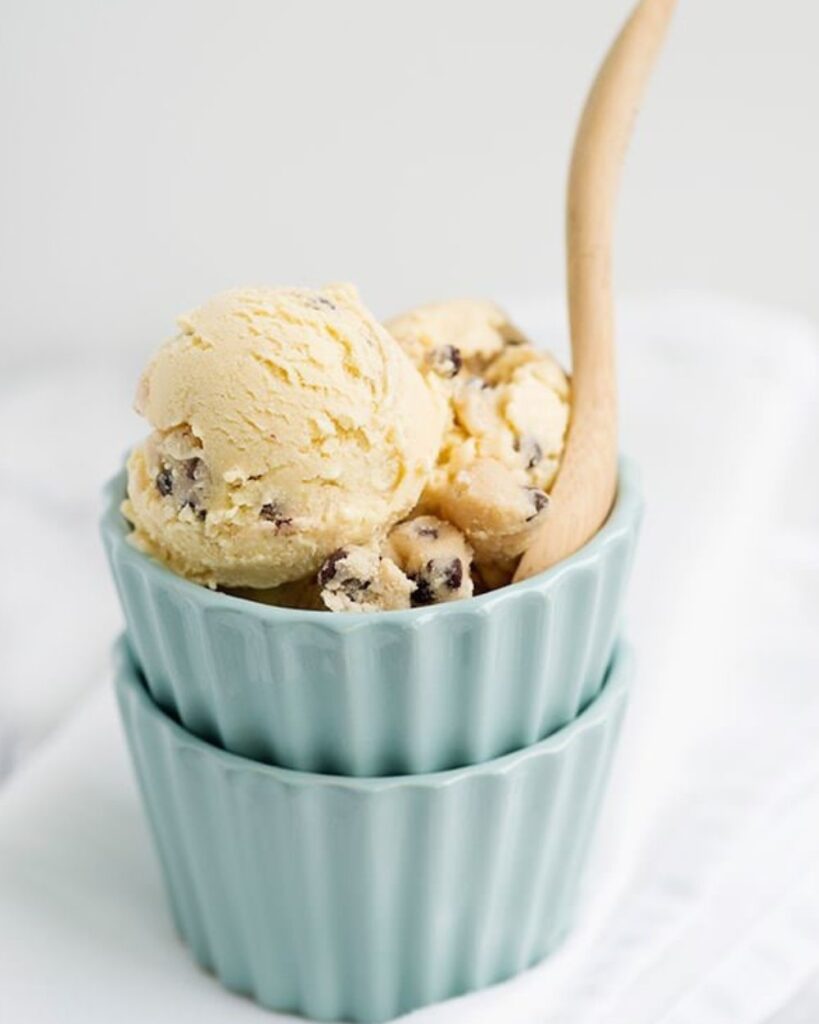 A bowl of creamy ice cream topped with chocolate chips, inviting and ready to be enjoyed.
