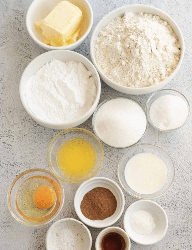 2 cups all-purpose flour,
1 teaspoon baking powder,
1/2 teaspoon baking soda,
1/2 teaspoon salt,
3/4 cup unsalted butter, softened,
1 cup granulated sugar,
1 large egg,
1 teaspoon vanilla extract,
1 tablespoon ground cinnamon,
1/2 cup brown sugar,
1/2 cup powdered sugar,
2 tablespoons milk (for icing)