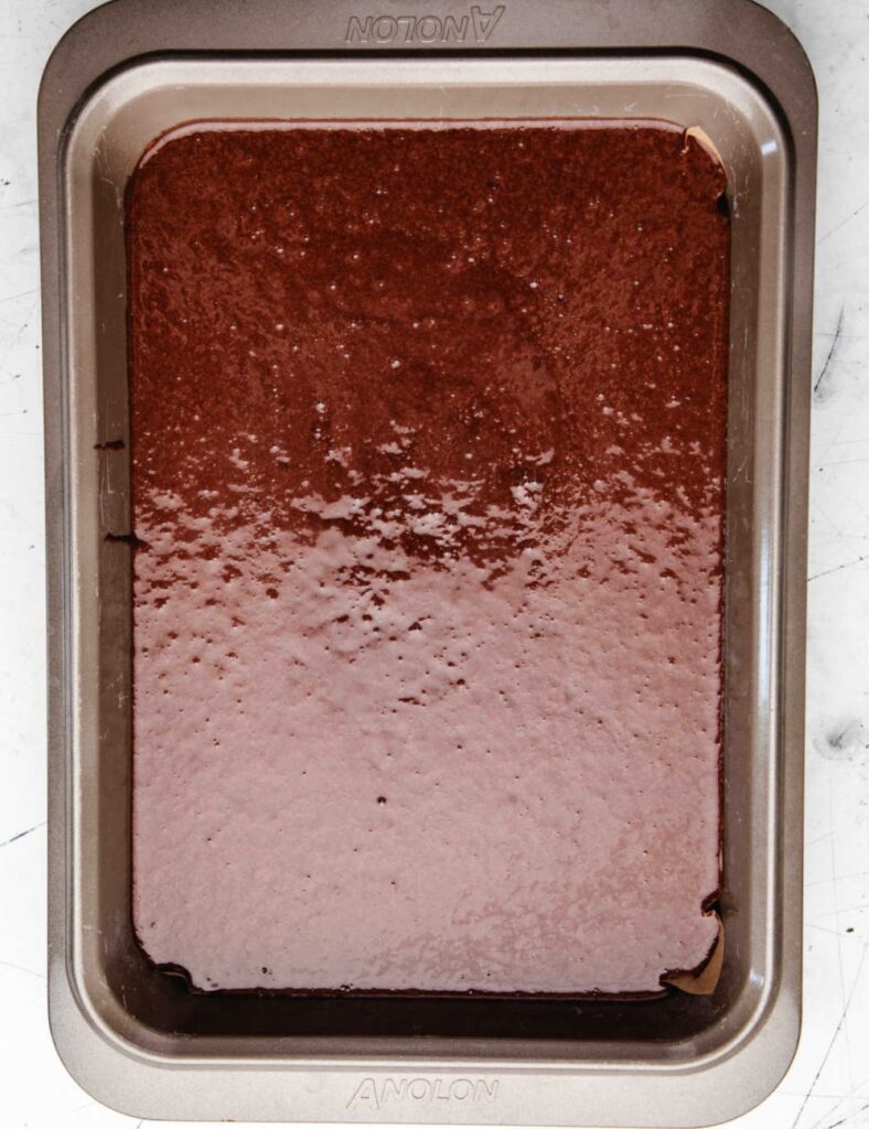 Pour the batter into the prepared sheet pan, spreading it evenly. Bake for 30-35 minutes, or until a toothpick inserted into the center comes out clean. 