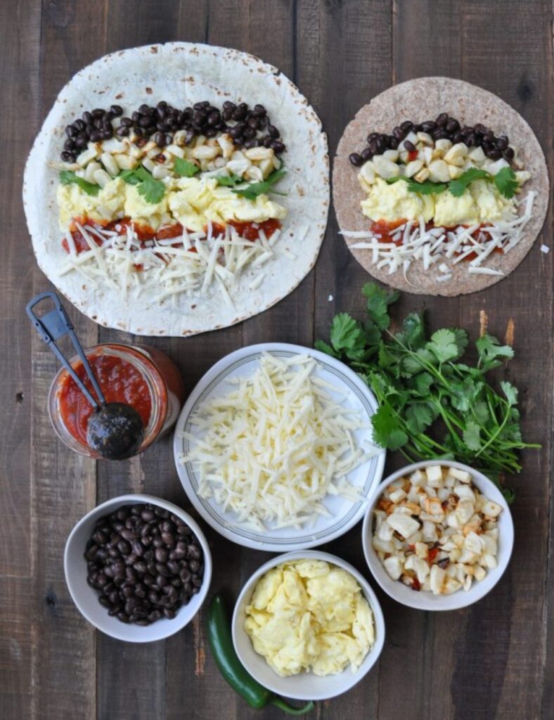 4 large flour tortillas

6 eggs

1/2 cup shredded cheese (cheddar or your choice)

1/2 cup diced bell peppers

1/2 cup diced onions

1/2 cup cooked sausage or bacon (optional)

Salt and pepper to taste

Salsa and avocado for serving (optional)