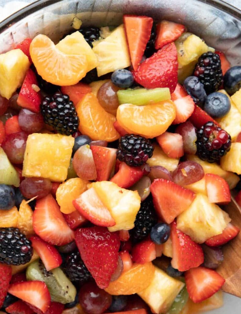 Colorful and fresh easy fruit salad served in a bowl with a mix of seasonal fruits.