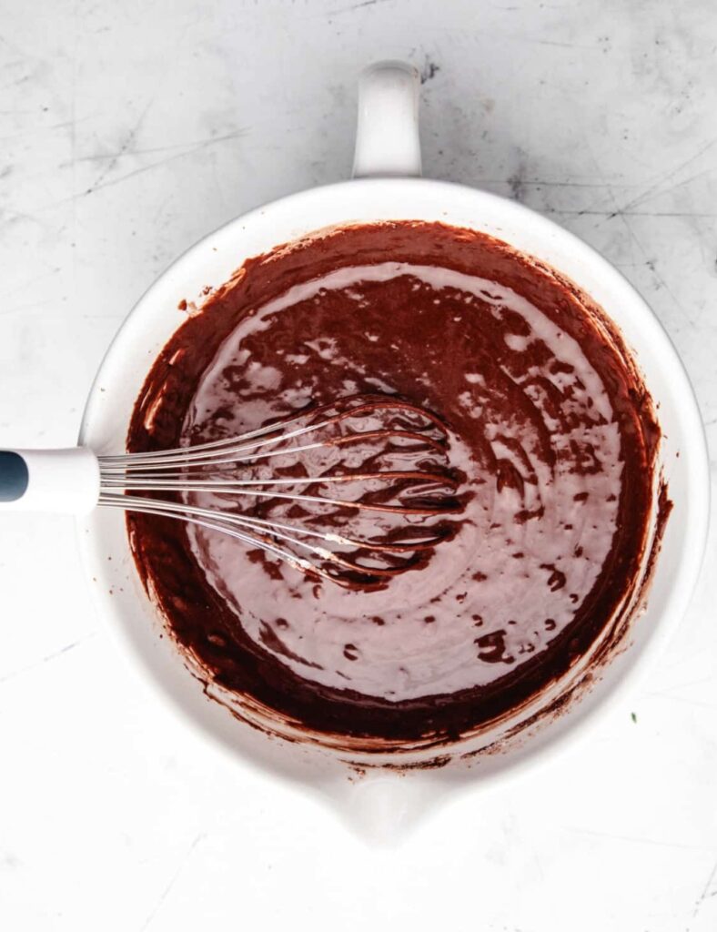 Add the eggs, whole milk, vegetable oil, and vanilla extract to the dry ingredients. Mix everything together until it’s well combined and smooth. 