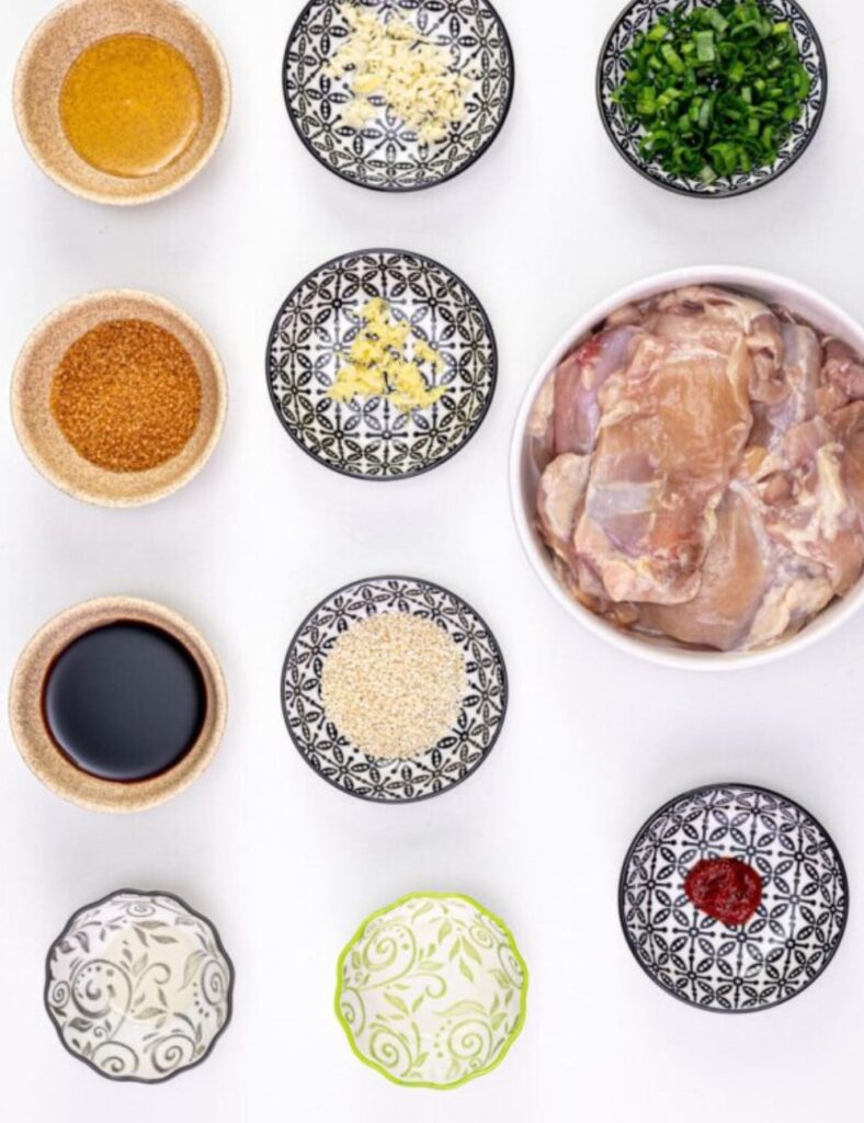 2 lbs chicken thighs or drumsticks

1/4 cup soy sauce

2 tablespoons brown sugar

1 tablespoon sesame oil

3 cloves garlic, minced

1 tablespoon ginger, minced

1 tablespoon gochujang (Korean chili paste)

2 green onions, chopped

Sesame seeds for garnish