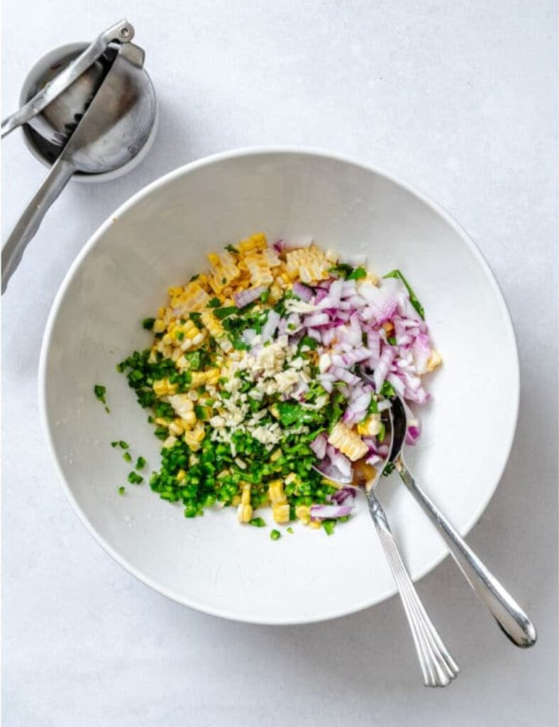 a bowl of food with spoons