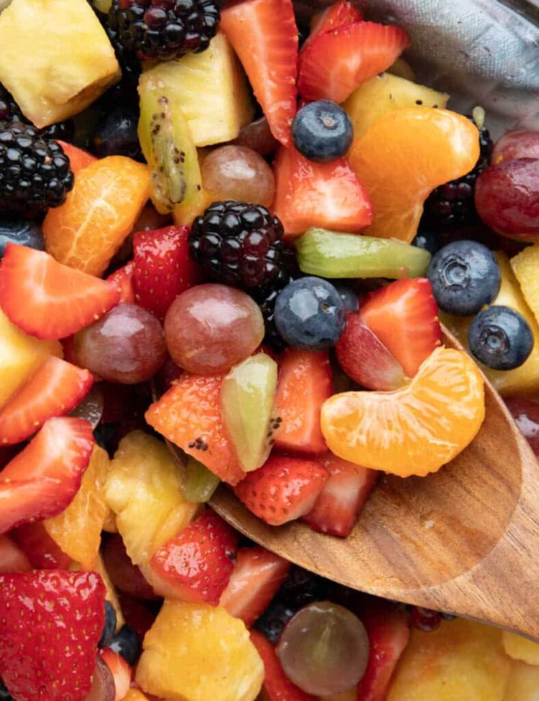 Colorful and fresh easy fruit salad served in a bowl with a mix of seasonal fruits.
