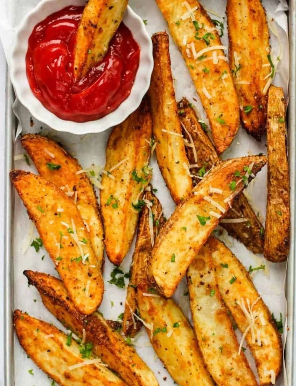 Golden crispy air fryer potato wedges served in a bowl