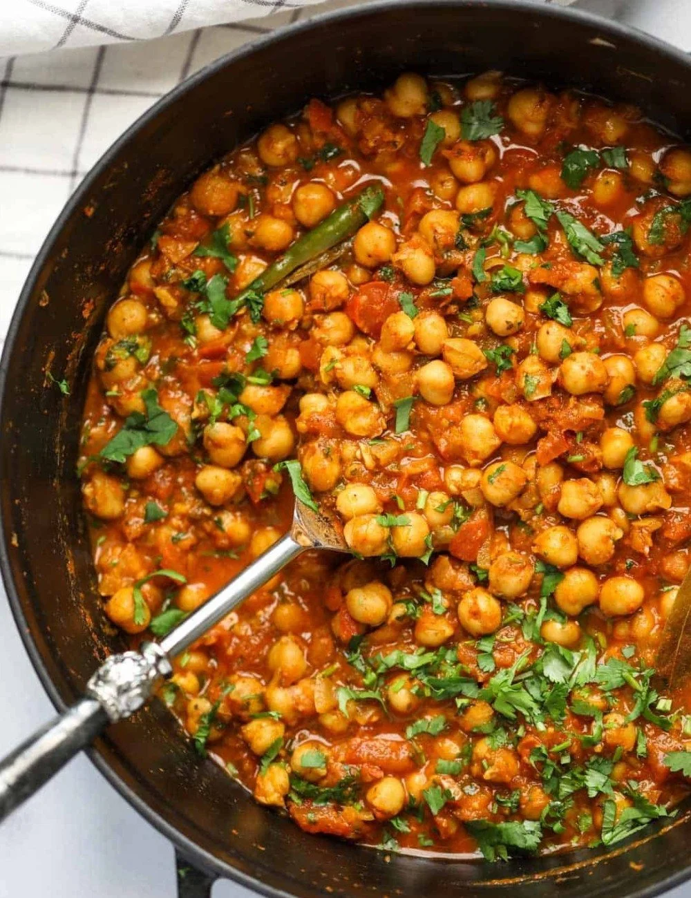 Bowl of authentic Chana Masala with spices and herbs