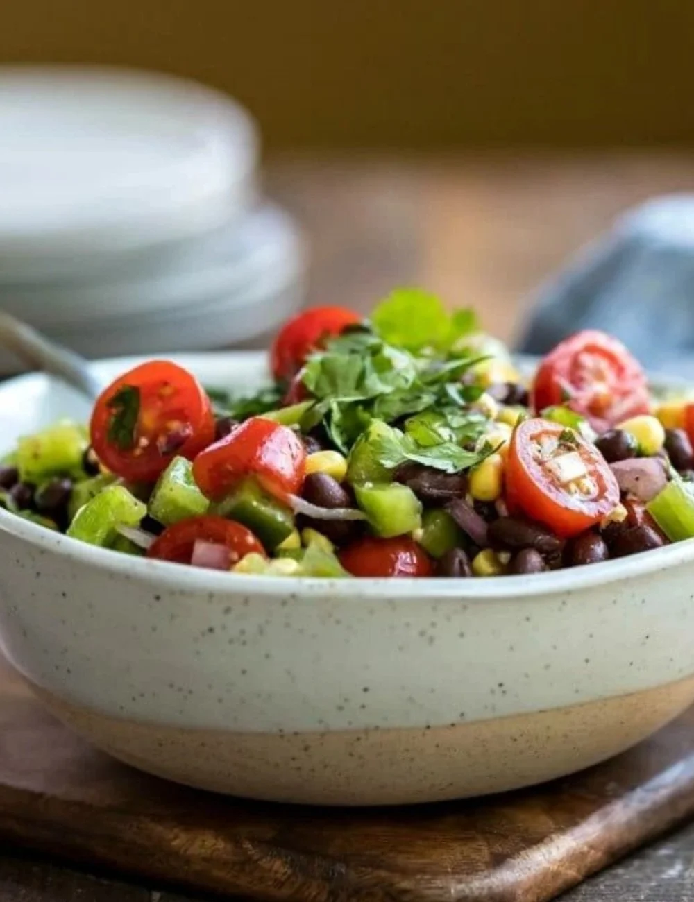 Colorful black bean salad with fresh vegetables and herbs