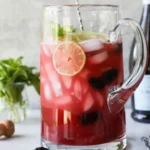 Blackberry Lime Prosecco cocktail garnished with fresh blackberries and lime