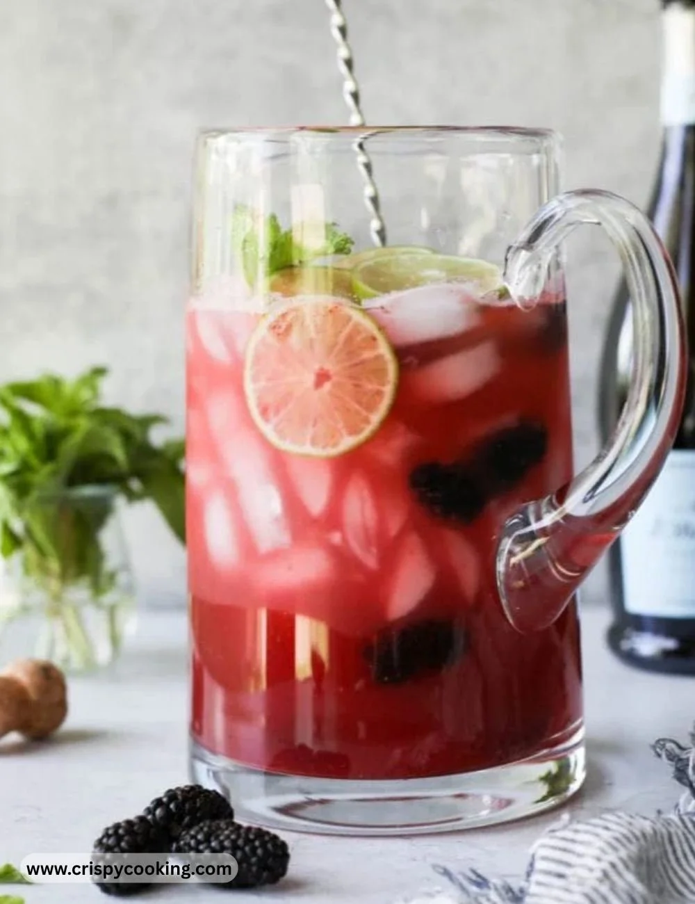 Blackberry Lime Prosecco cocktail garnished with fresh blackberries and lime