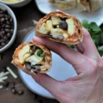 Delicious breakfast burritos filled with eggs, cheese, and veggies
