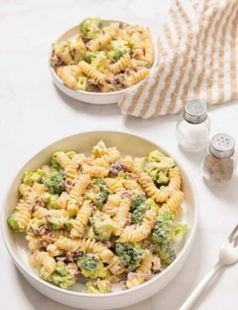 Fresh broccoli pasta salad with colorful vegetables and dressing