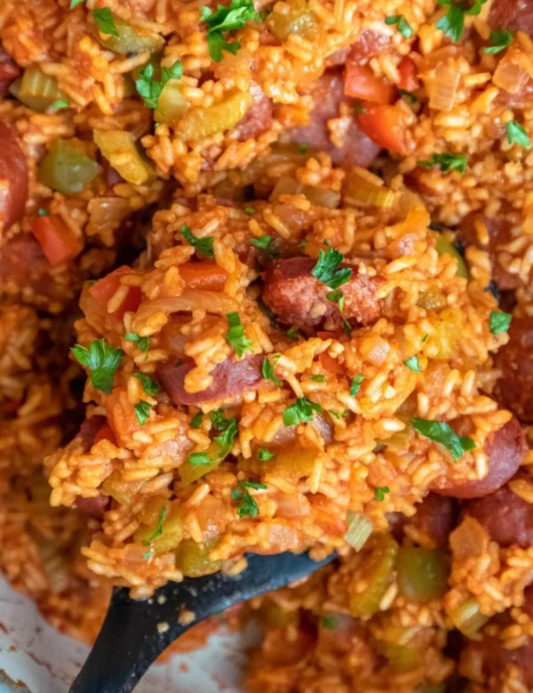 Delicious Cajun sausage and rice served in a bowl with fresh herbs.