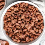 Bowl of delicious homemade candied almonds with a caramelized glaze