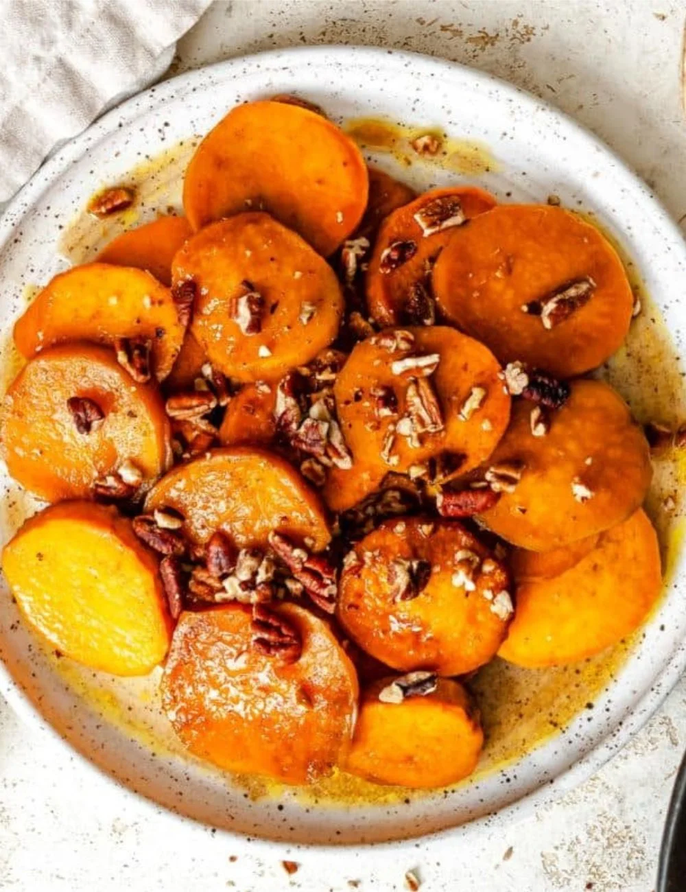 Bowl of candied sweet potatoes glazed with brown sugar and spices