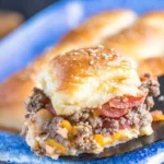 Delicious cheeseburger sliders served on a platter with condiments