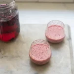 Delicious Cherry Smoothie topped with fresh cherries and mint leaves