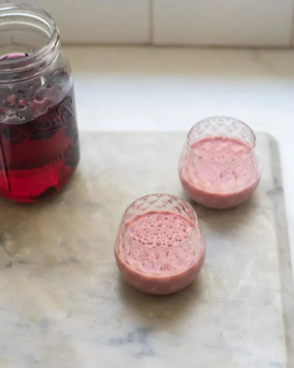 Delicious Cherry Smoothie topped with fresh cherries and mint leaves