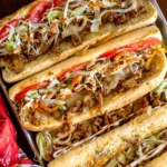 Chicken Philly Cheesesteak with cheese, peppers, and onions in a sub roll