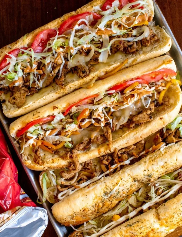 Chicken Philly Cheesesteak with cheese, peppers, and onions in a sub roll