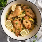 Delicious Chicken Piccata served with lemon and capers on a plate.