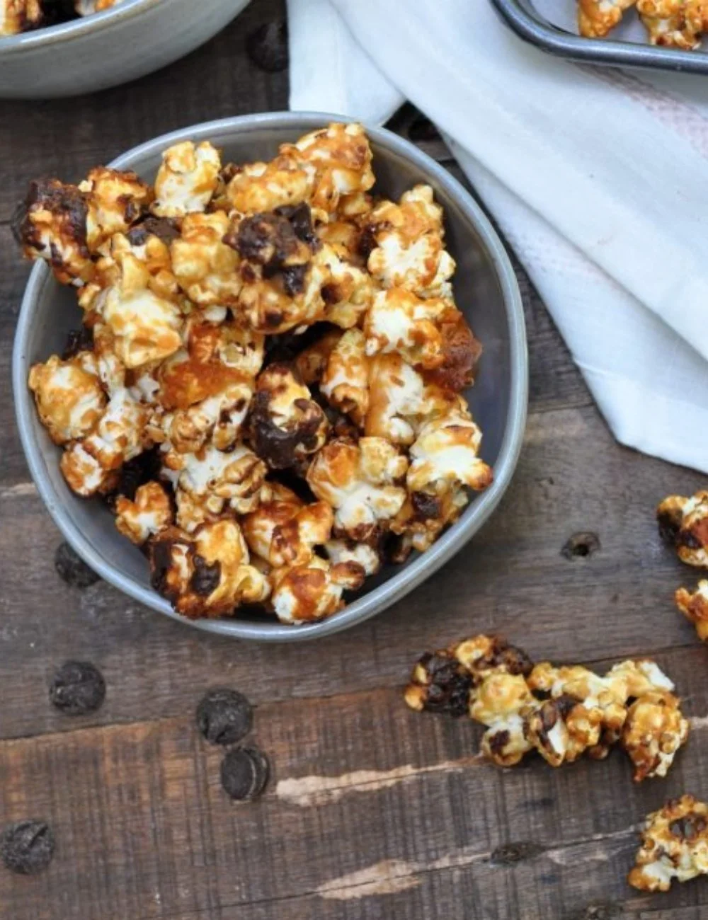 Bowl of chocolate peanut butter popcorn drizzled with chocolate and peanut butter