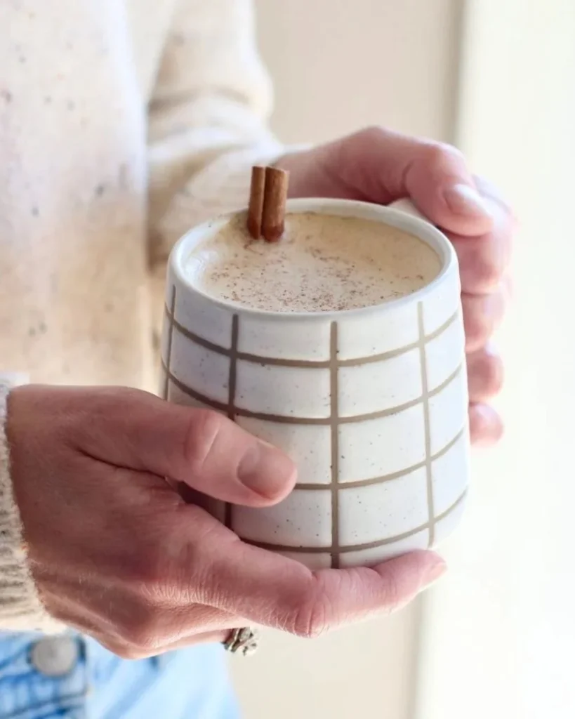 Cinnamon Coconut Latte served in a cup with spices and coconut flakes