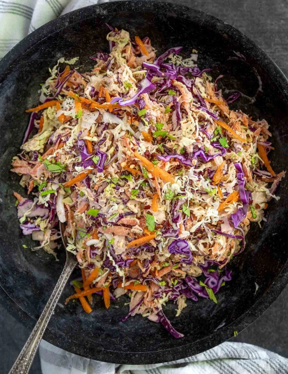 Delicious homemade coleslaw served in a bowl with fresh ingredients.