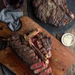 Juicy grilled T-Bone steak on a plate, garnished and ready to serve.