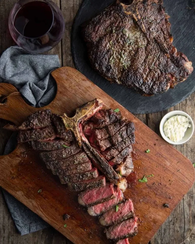 Juicy grilled T-Bone steak on a plate, garnished and ready to serve.