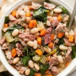 Bowl of easy ham and bean soup garnished with herbs