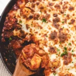 One-pan baked tortellini dish topped with cheese and herbs