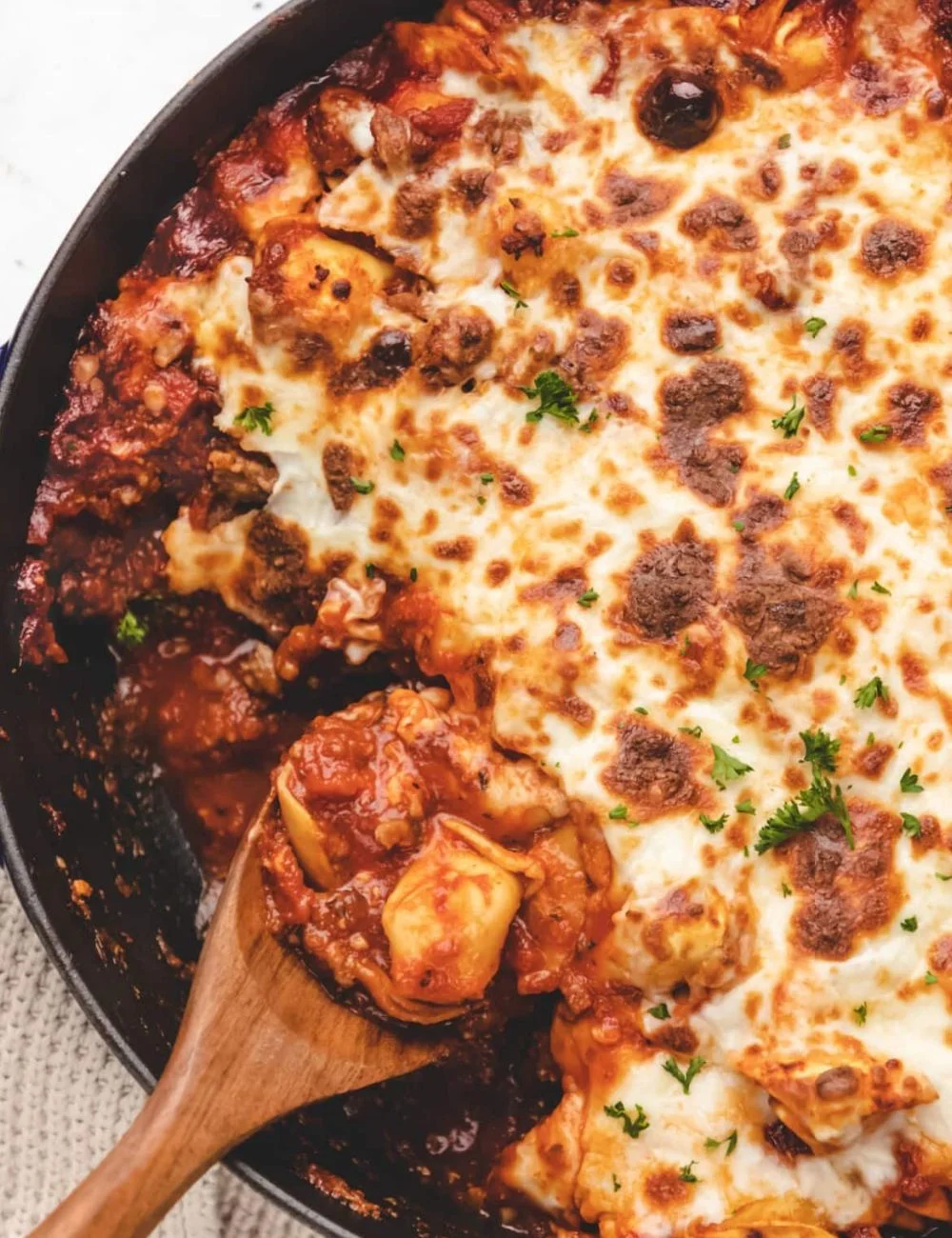 One-pan baked tortellini dish topped with cheese and herbs
