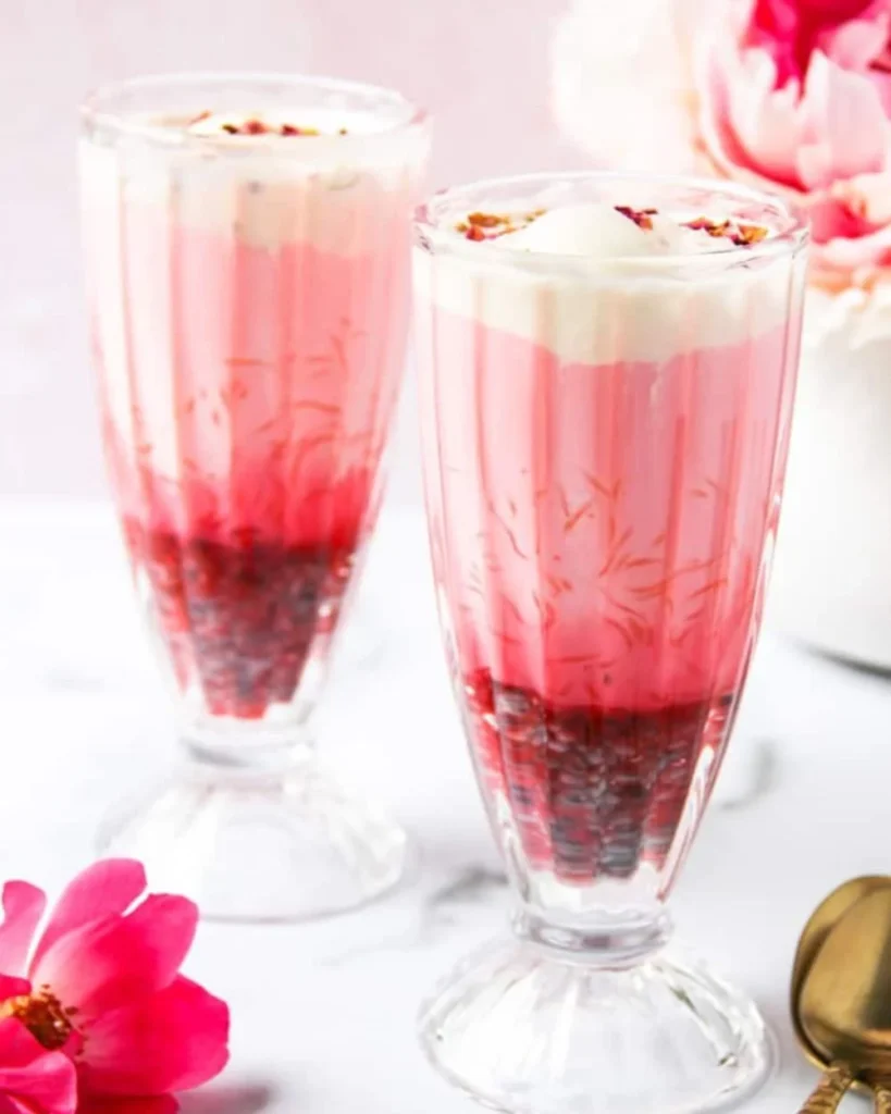 Delicious falooda dessert with vermicelli and ice cream topped with rose syrup