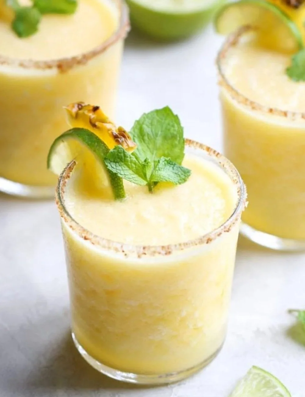 Refreshing Frozen Pineapple Margaritas in a glass with pineapple garnish