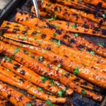 Beautifully glazed grilled carrots on a platter, perfect for summer grilling
