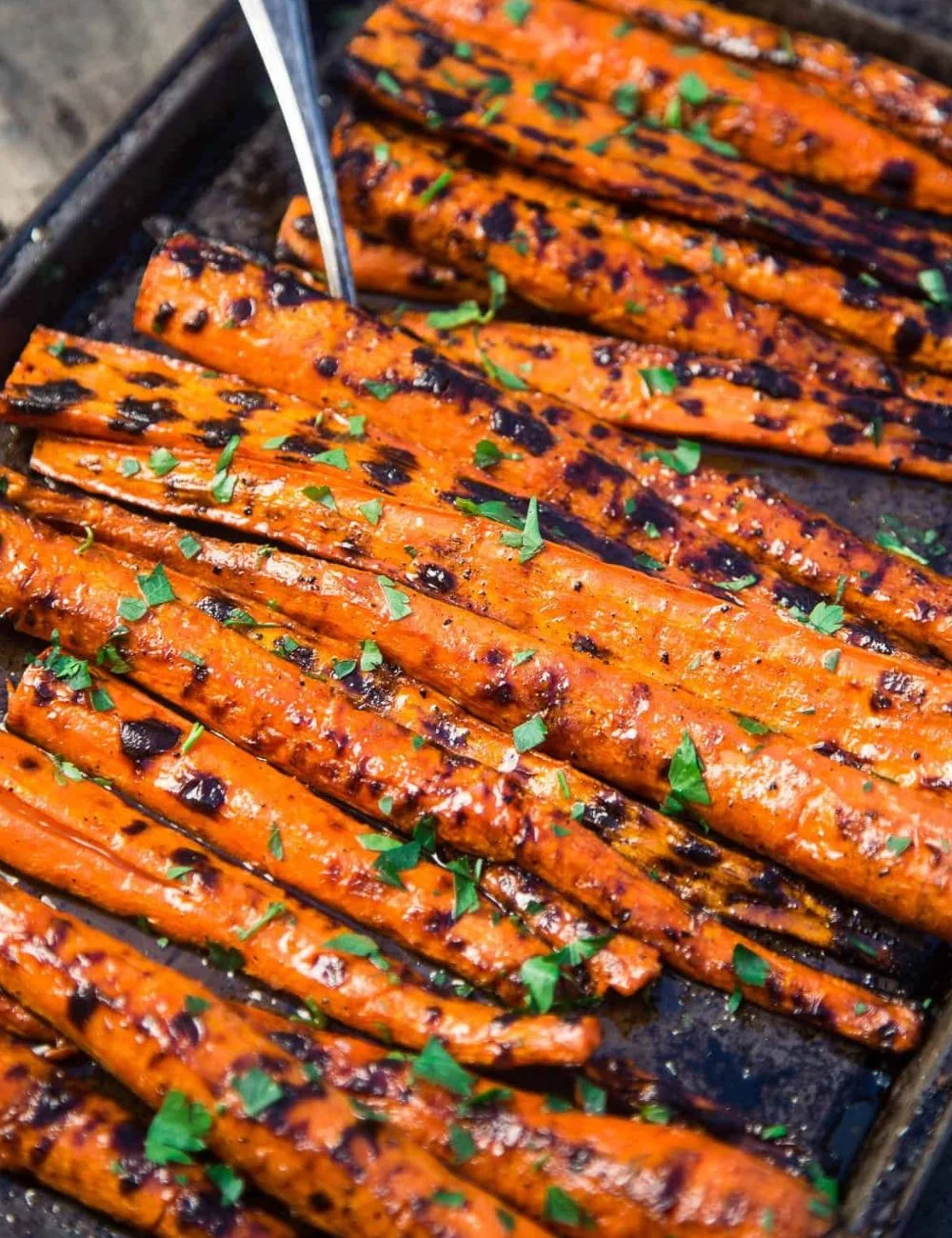 Beautifully glazed grilled carrots on a platter, perfect for summer grilling