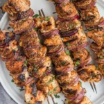 Delicious grilled chicken kabobs served on skewers with colorful vegetables.